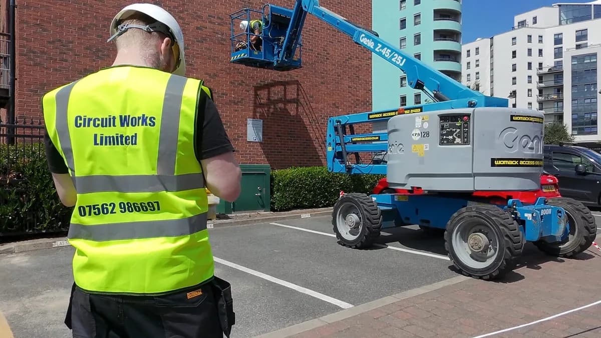Circuit Works electrician on site in branded hi-vis vest