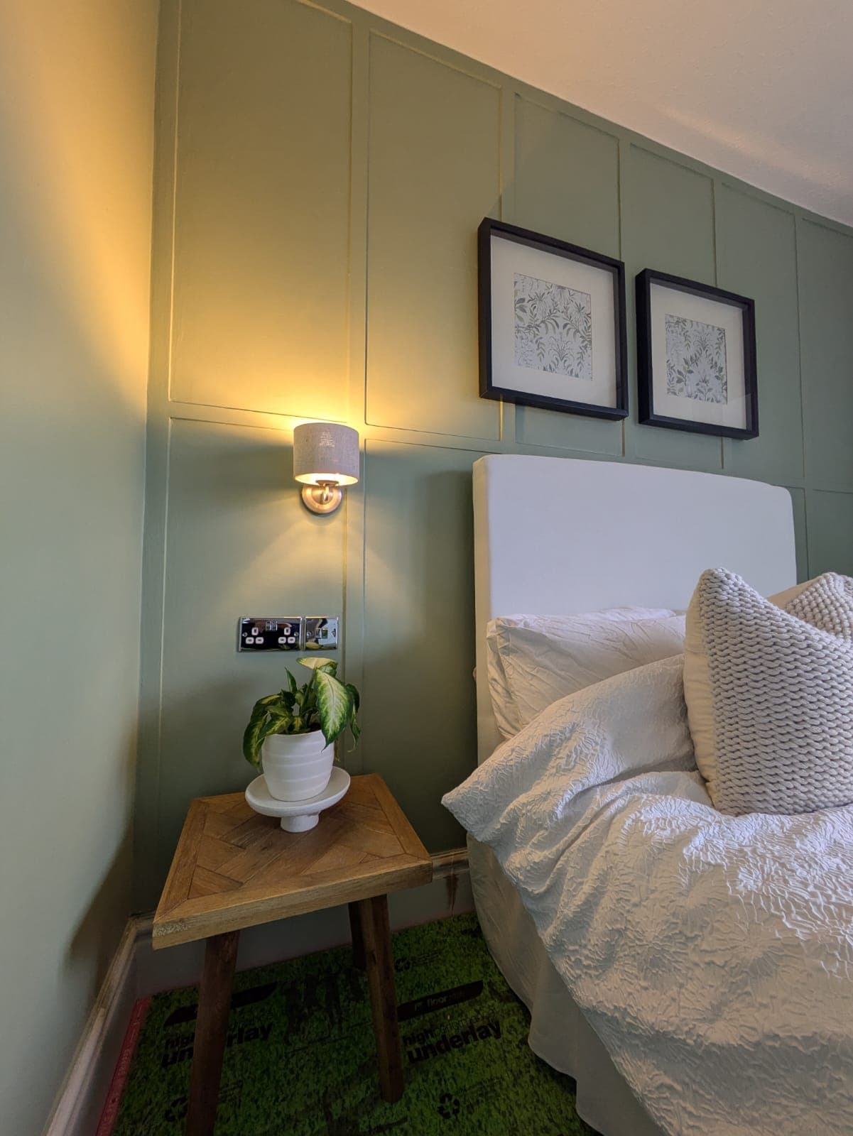 Stylish bedroom with pendant lights and bedside wall lights